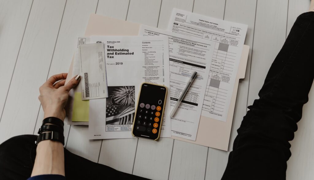 Freelancer organizing receipts and tax documents for June 15 quarterly deadline